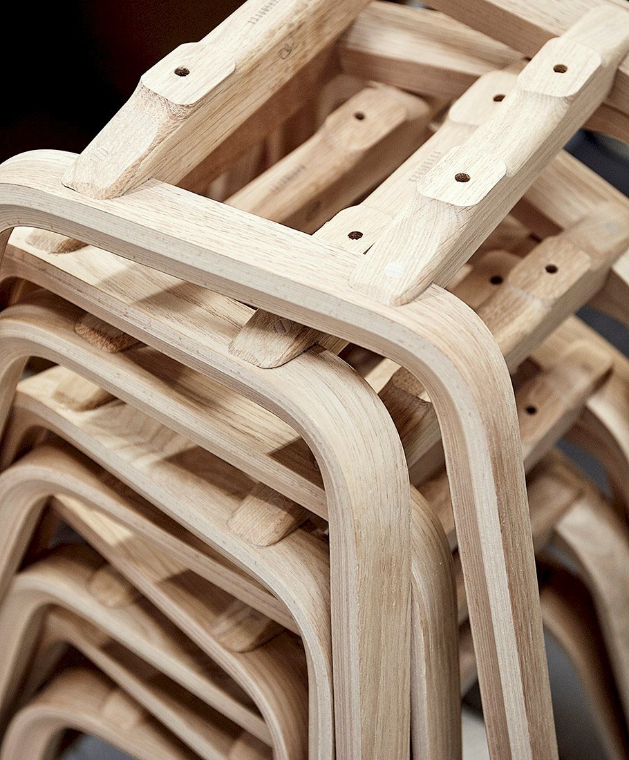 Stacked raw oak chair frames, moulded and drilled, at the Kvist factory in Varde (FSC production).