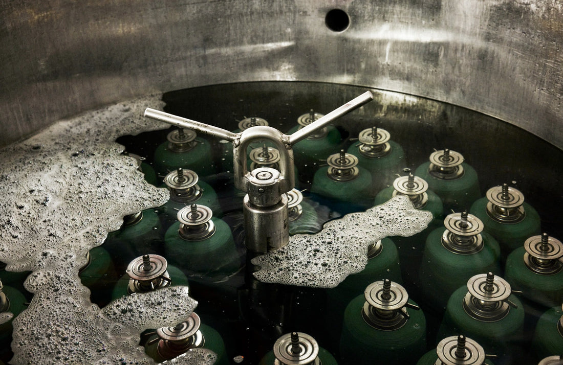 Yarn bobbins in the dye vat at the dye works near Innvik, Norway, for the fabric Sisu.